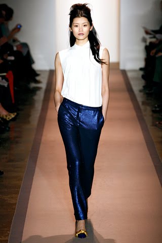 Model from Peter Som's fall 2011 ready-to-wear collection wearing metallic blue pants, a sleeveless white shirt and flats