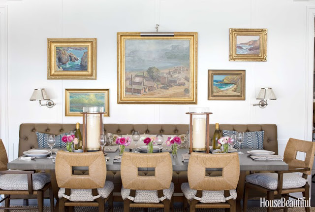 gorgeous dining room with leather sofa, accent lights and paintings by Peter Dunham