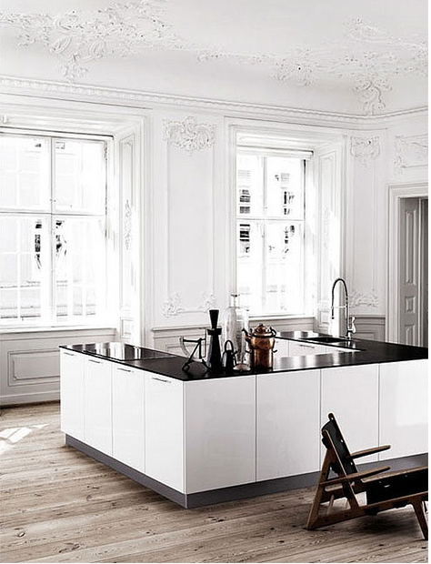 Black and white kitchen with aged wood floors