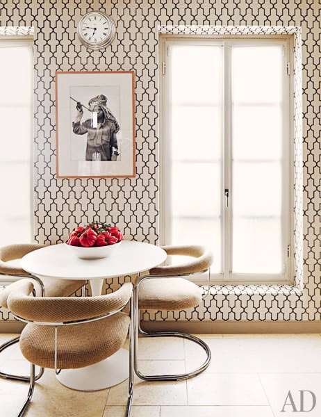 Breakfast nook with floor to ceiling Moroccan style Phillip Jeffries printed wallpaper, round table and modern chairs