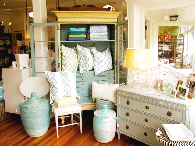 COCOCOZY pillows in light blue and sage as part of a display
