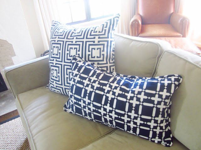 Navy COCOZY Logo and COCOCOZY Plaid Solid pillows on a neutral sofa