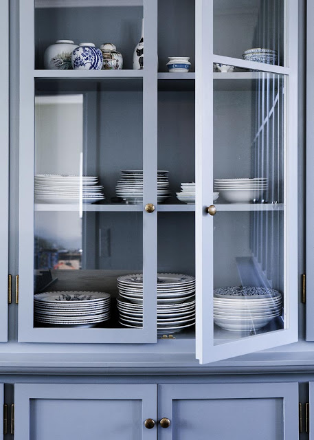 close up of kitchenware in the blue cabinets 