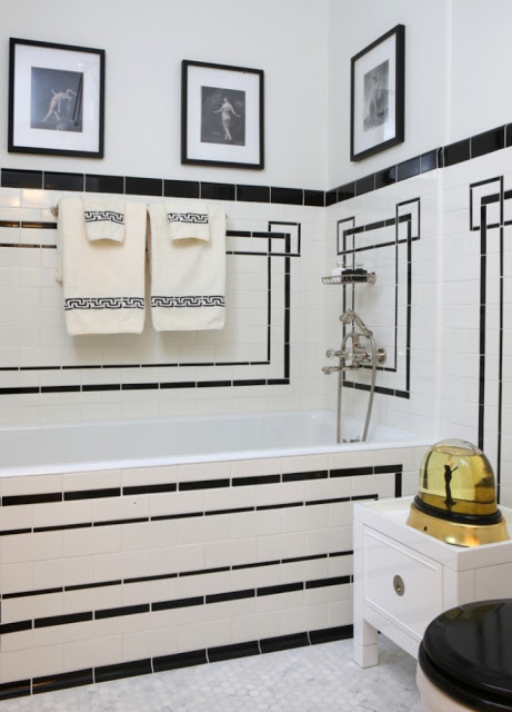 Jessica Lagrange's black and white tiled bath tub and white towel holder stand