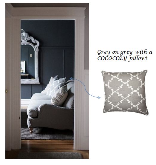 Grey COCOCOZY pillow on a grey sofa in a living room with dark grey walls and a traditional white mirror