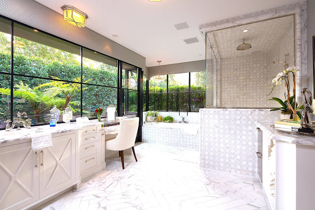 White marble master bathroom wrap around windows
