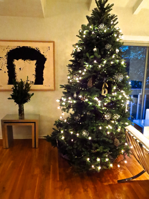 Christmas tree next to a Richard Serra print 