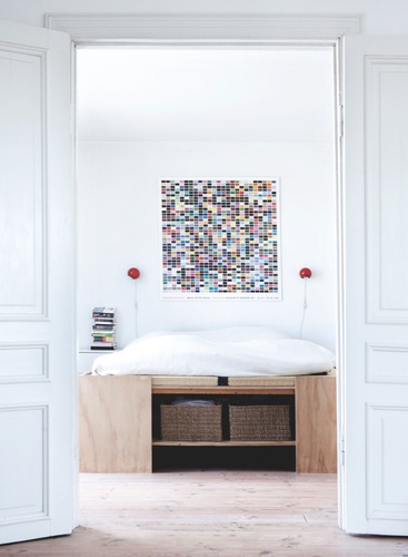 White modern Danish bedroom with raised bed