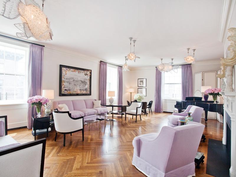 lavendar living room in a Park Avenue Apartment with herringbone wood floors, crystal fish light fixtures, lavender curtains with a matching sofa and upholstered armchairs, a baby grand piano and a fireplace