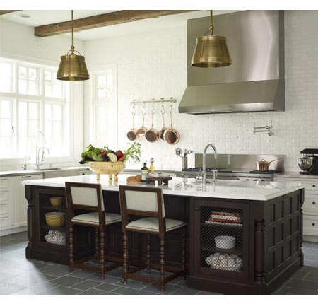 bella casa design's kitchen with brass pendant lights and a wood island with marble counter top