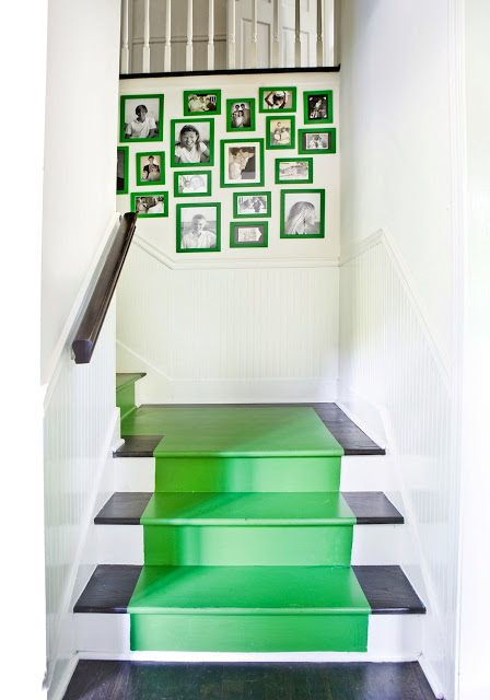Staircase with kelly green stairs matching bright green framed pictures arrangement