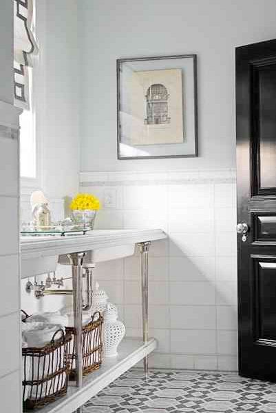 Bathroom with a black lacquer door, mosaic tile floor, and chrome sink