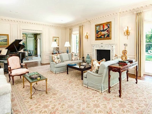 Traditional living room in a Palm Beach estate with paneled walls, dentil molding and a grand piano