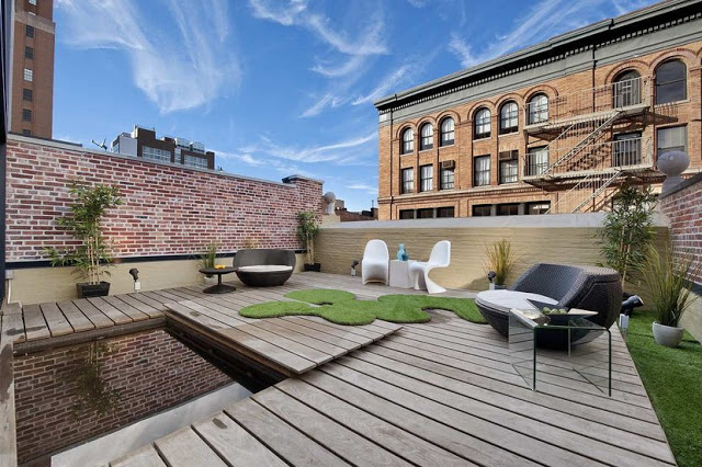 deck with white panton chairs, exposed brick walls and wood floor