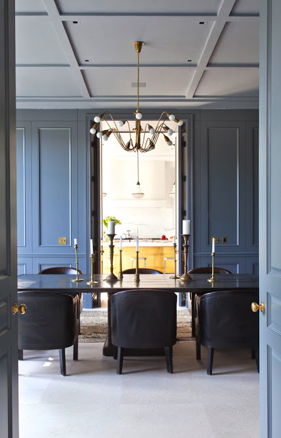 alternative view of a formal dining room with steel painted paneled walls, white coffered ceilings and brass accents