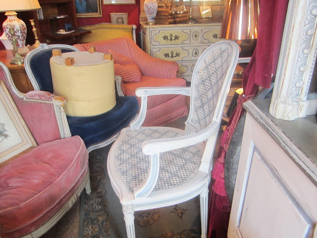 Coco's Paris flea market find: a set of four grey painted trellis pattern on a white cane back armchairs