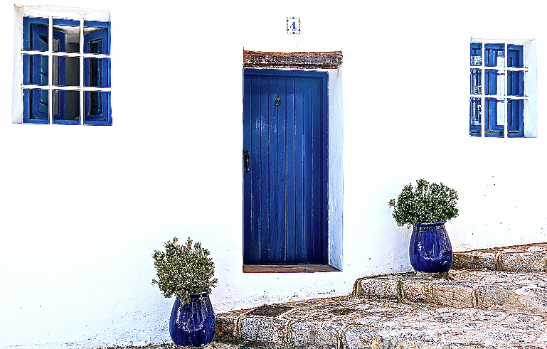Blue door in a white home