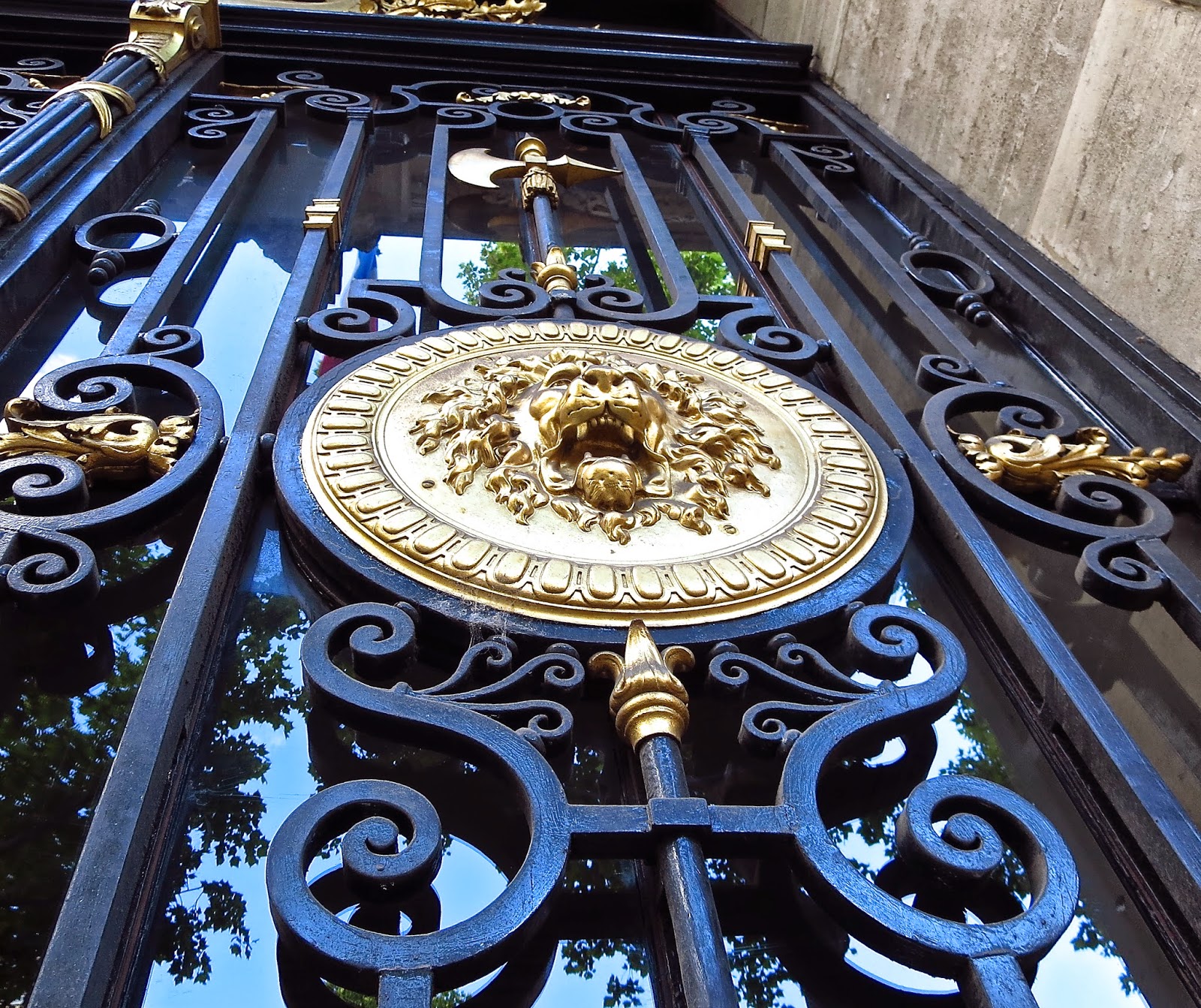 Metal and glass door in Paris with gold medallions
