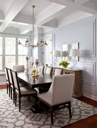 Dining room with mismatched chairs and a graphic print rug
