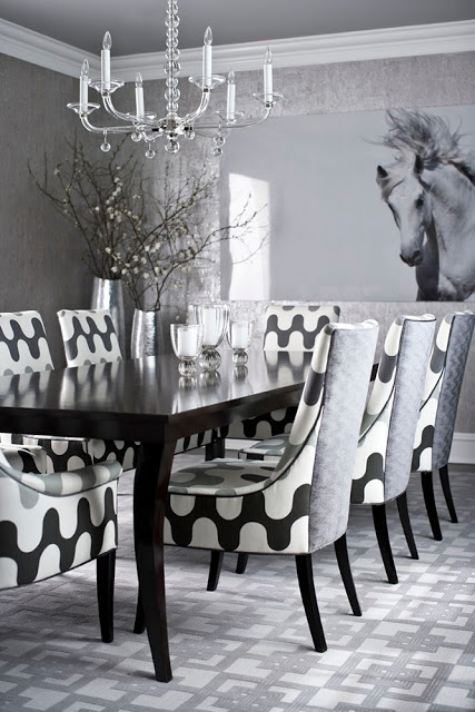 Grey dining room by Muse Interiors with graphic carpeting and chairs