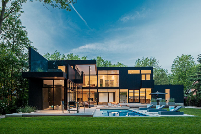 Exterior of a modern black house with a pool