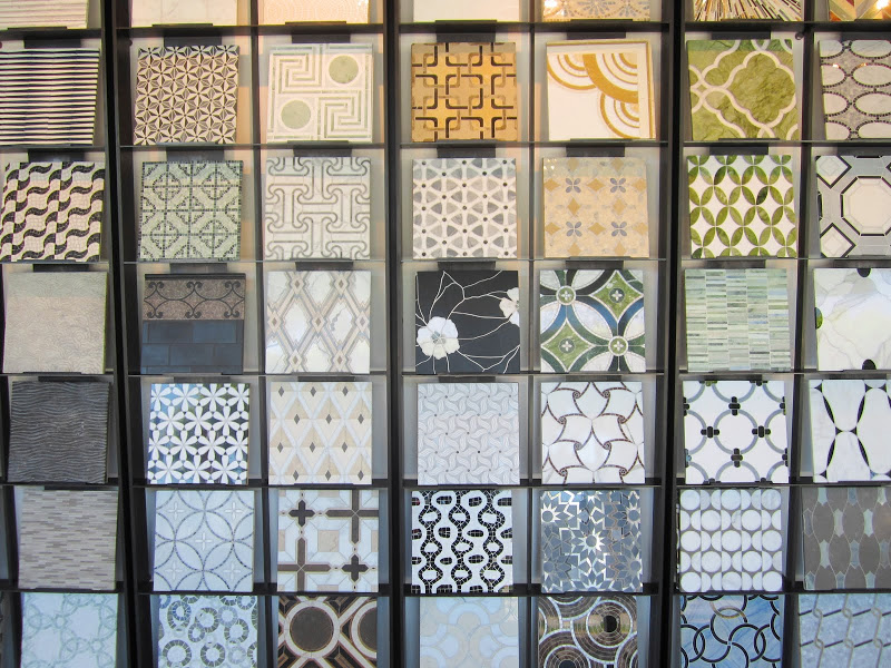wall of marble mosaic tile samples in mostly neutral colors
