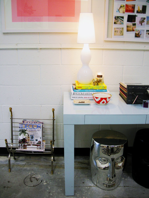 Office with a light blue glossy Parsons Desk, a silver garden stool and vintage magazine rack
