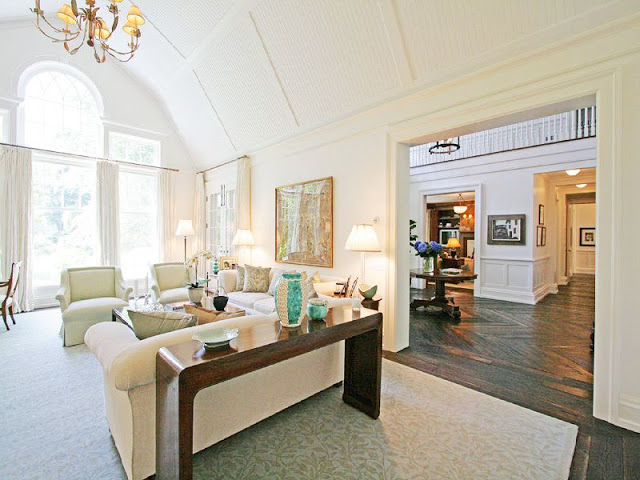 Livng room with high white gambrell ceilings, a fireplace, traditional decor and a view to foyer
