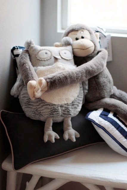 a monkey and owl stuffed animal hugging