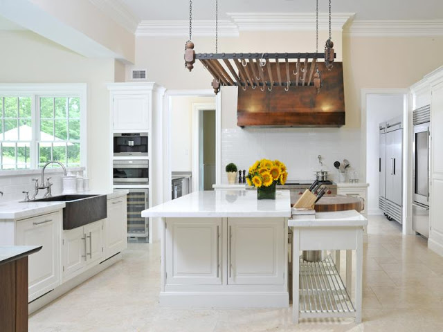 alternative view of the white kitchen with view of copper hood and farmhouse sin