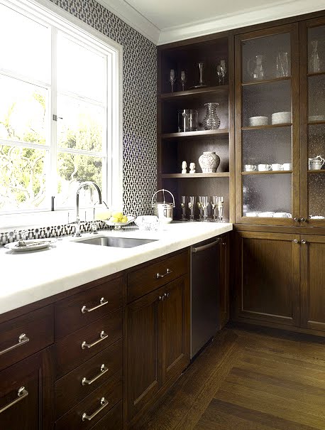 Kitchen with black and white Moroccan tiles, wood cabinets and white marble counter tops by House of Fifty