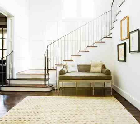 Foyer with Louis XVI bench, staircase, area rug and dark wood floor