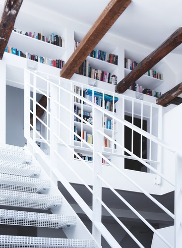 White stairs to the second floor with built in book cases