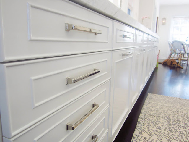 Close up of white panel cabinets with polished nickel drawer pulls