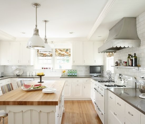 rehkamp larson architects' vintage kitchen roper stove with scalloped hood, butcher block island counter and pendant lights