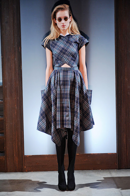 Model from Carven's Fall RTW 2011 is wearing a blue and grey plaid dress with pockets, black tights and heels