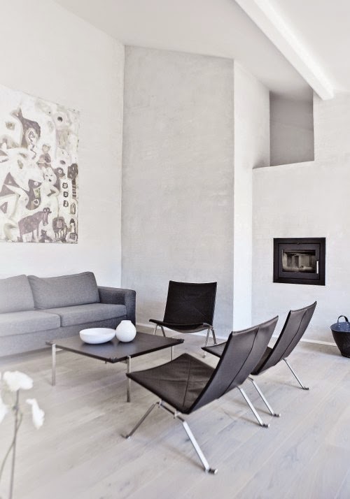 Modern living room with grey sofa in home by Norm Architects