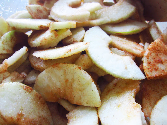 cut and peeled Granny Smith apples coated in cinnamon and sugar for a pie filling