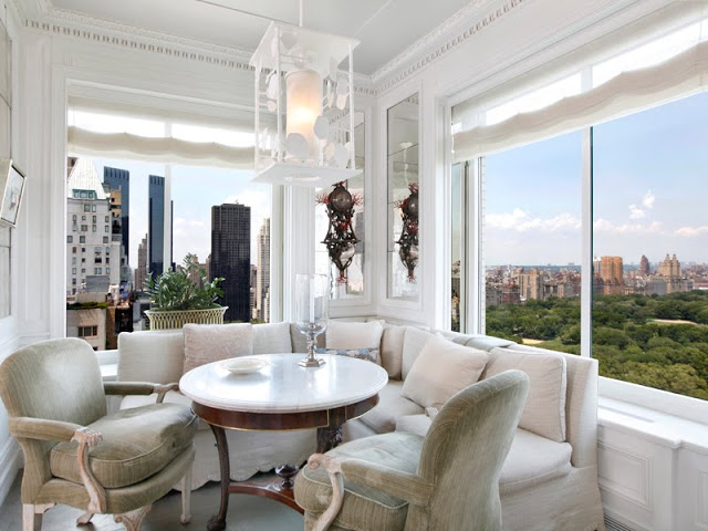Breakfast nook with an amazing view of Central Park in NYC with a sectional sofa and armchair instead of traditional seats
