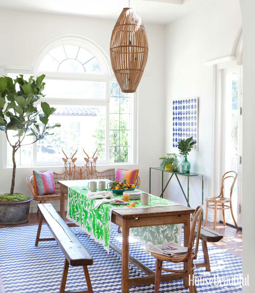 Todd Nickey and Amy Kehoe of Nickey Kehoe's breakfast nook in their Malibu home featured in House Beautiful with modern rustic wood table and green table runner