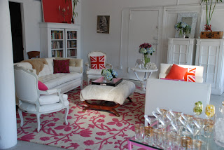 White living room with pink and white floral rug and Union Jack pillows