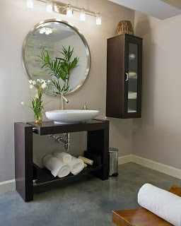 Modern bathroom vanity with a round mirror in a silver frame