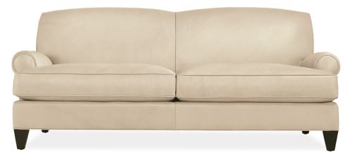 Off white upholstered sofa with tight curved back and rolled arms