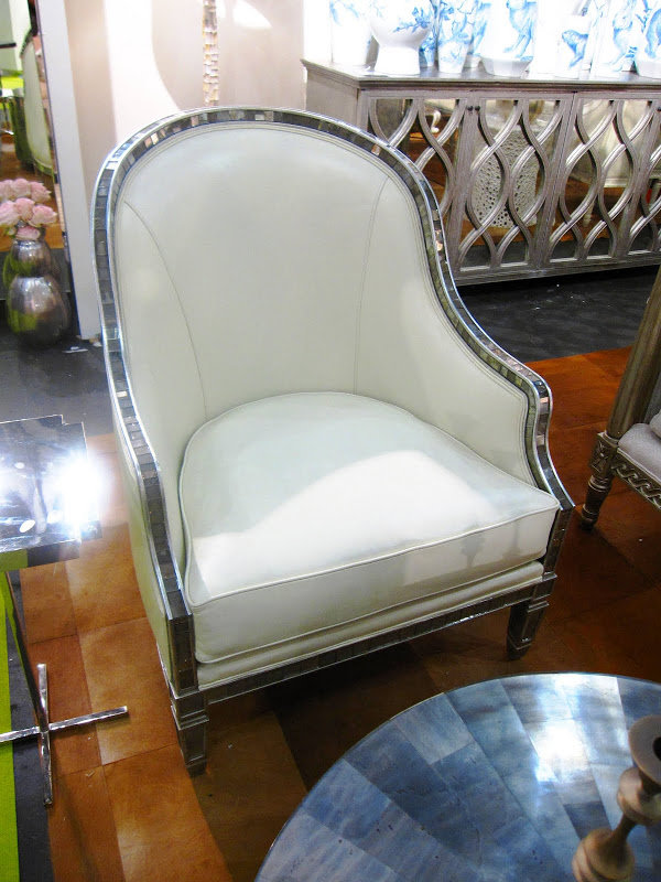 Tight backed leather upholstered armchair with small antique mirrored tile trim at the Oly booth at the New York International Gift Fair