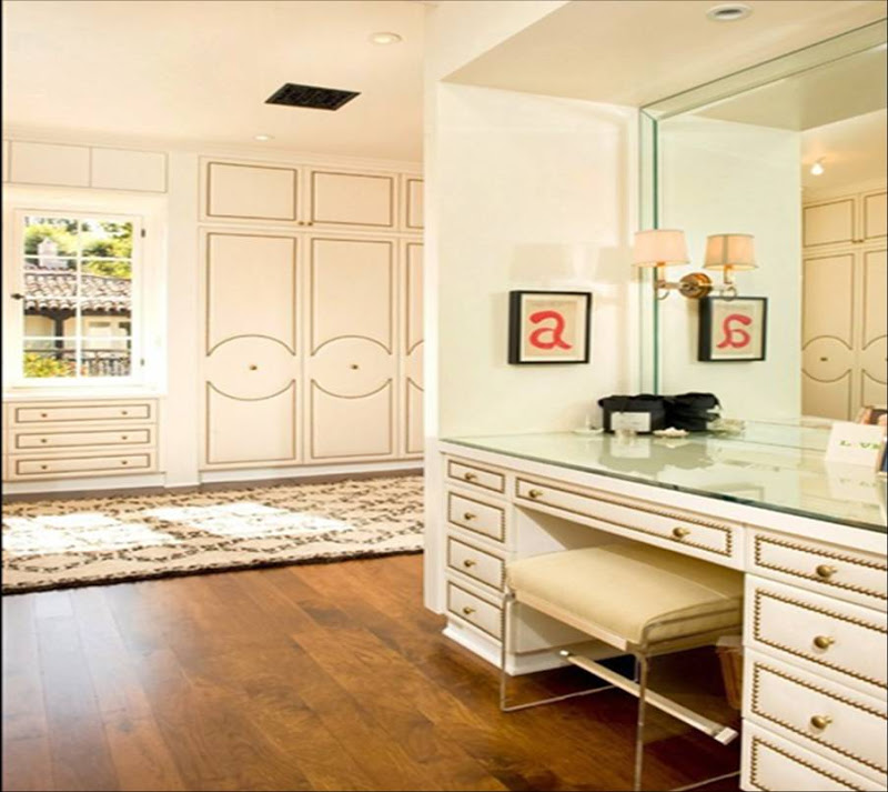 Dressing room by Todd Nickey and Amy Kehoe with nail head trim on the closet doors and vanity drawers