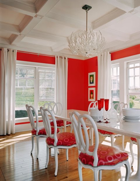 Red and white dining room by Ghislaine Vinas with coffered ceiling and red walls