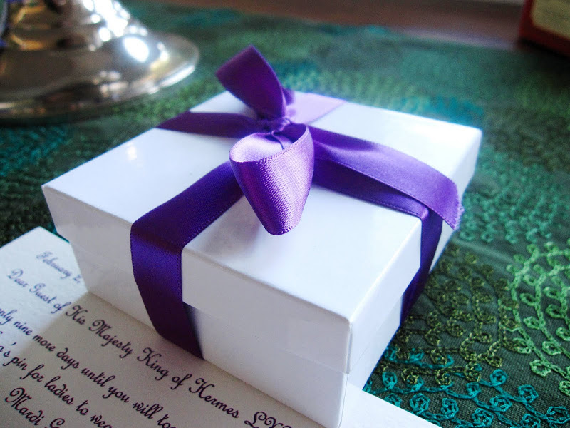 Gift with a purple bow in honor of Mardi Gras