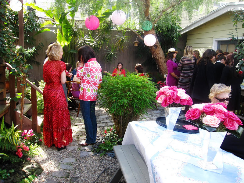 People mingling at a chic pink themed baby shower