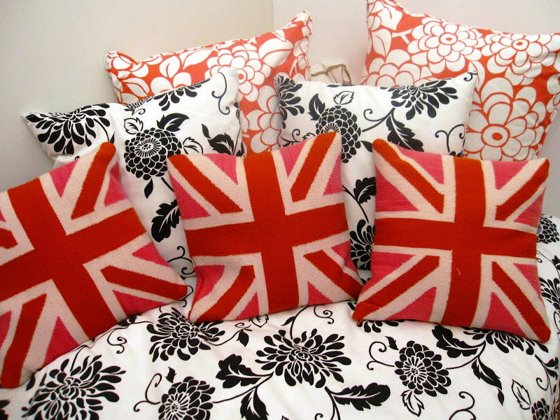 Jonathan Adler's British Flag pillows on black and white bedding on a daybed in a nursery