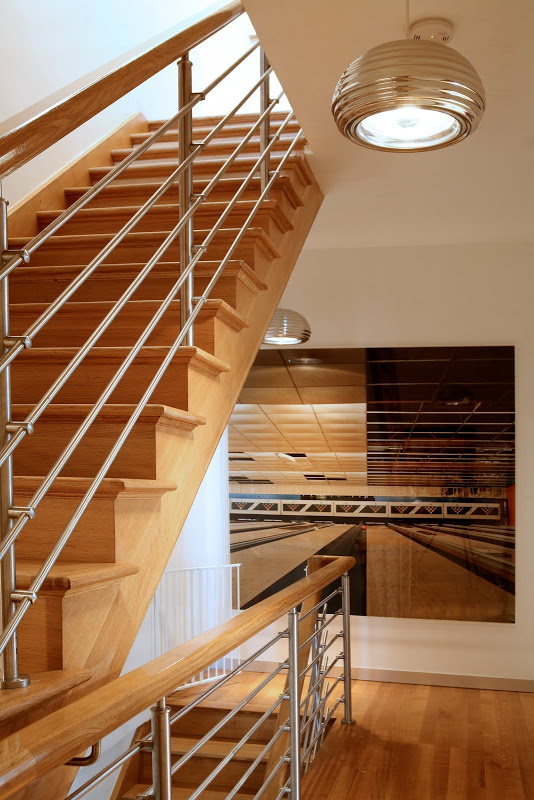 Wooden staircase with sliver rod baluster in a New York Townhouse by Sixx Design